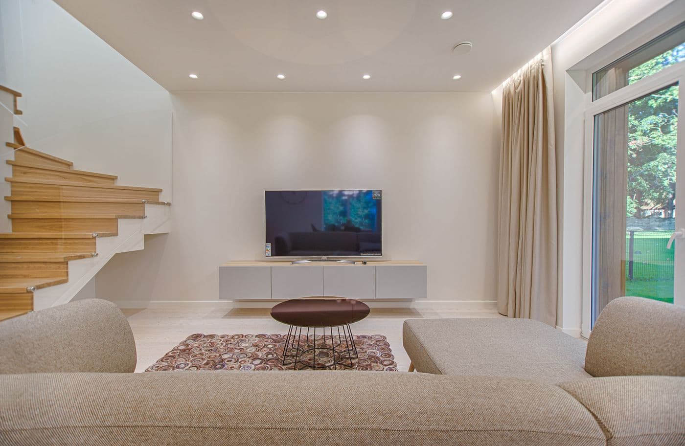 Contemporary living room with cleanly painted walls and a sharp transition into timber frames.