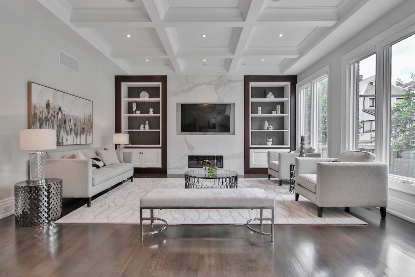 Large, evenly finished living-room walls in stone white, with sharp edges at ceiling and built-ins.